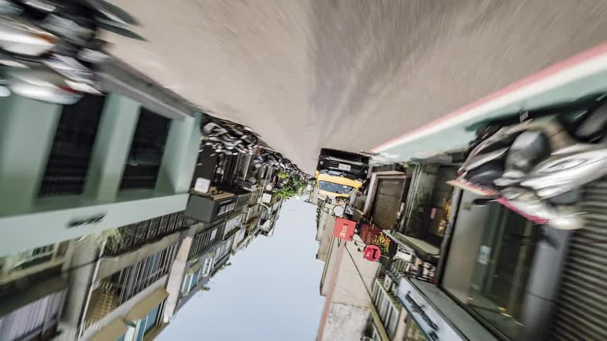 Cars and pedestrians commuting in a bustling city in the daytime