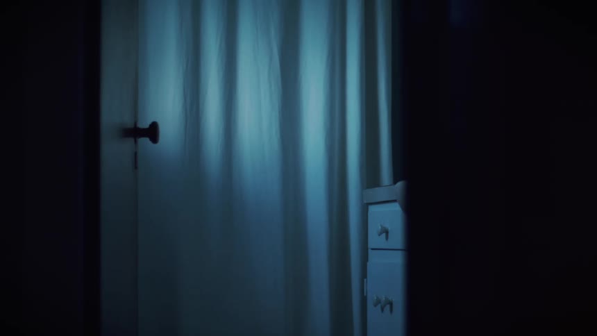 A closed door with a curtain in a home