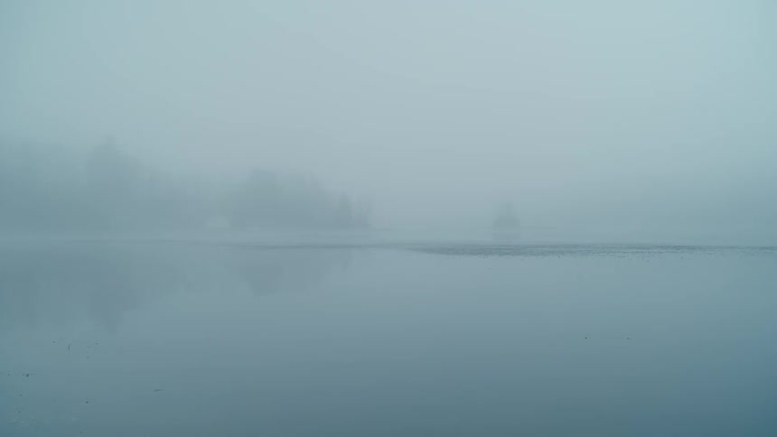 A calm lake on a hazy winter day