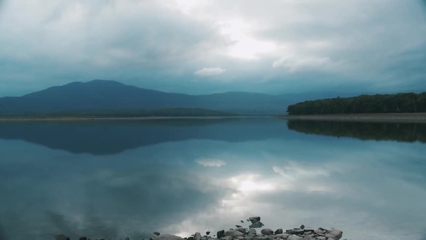 Clouds floating over a calm lake in nature on an overcast day