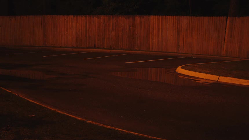 Empty parking spots in parking lot in a neighborhood