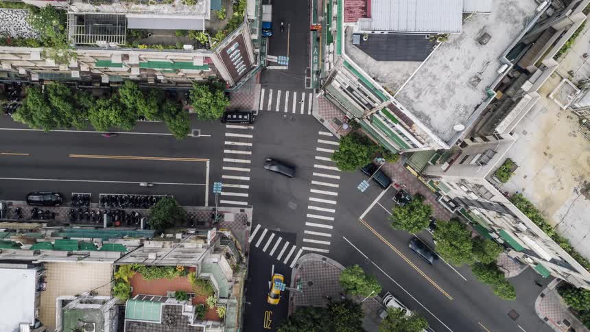 Cars commuting on a busy city street in the daytime