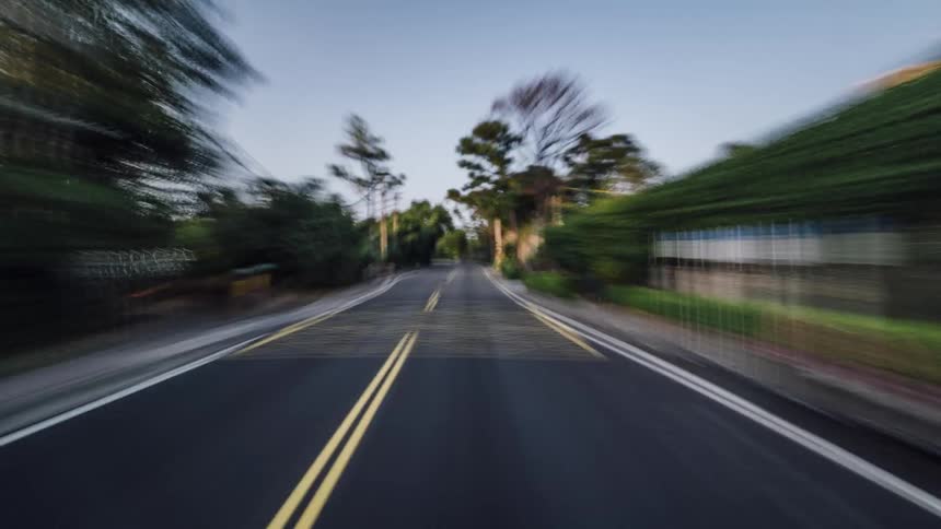 Time lapse of a vehicle driving on a road through small towns and countryside