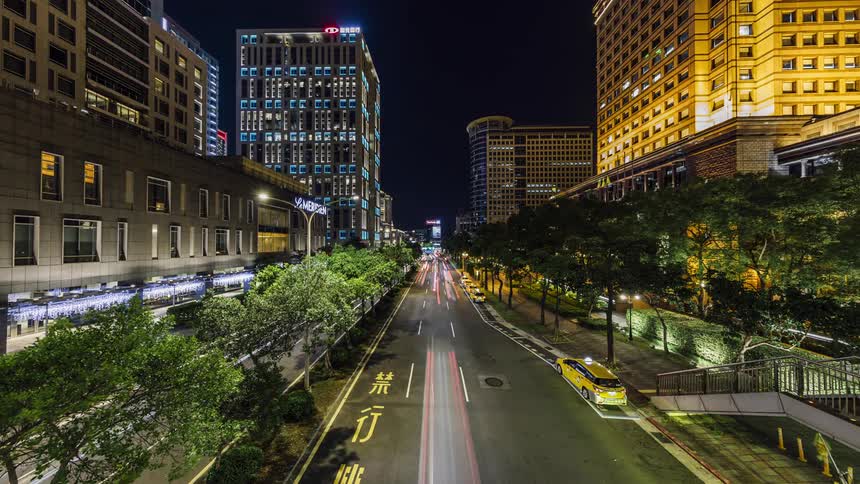 Downtown traffic in the city at night and lights on in the buildings