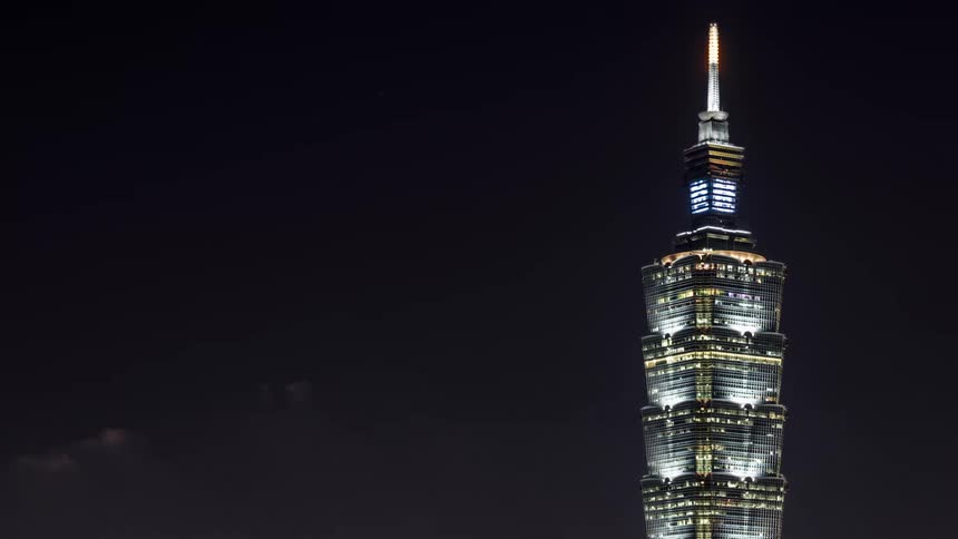 A time lapse of a high rise monument with clouds passing by
