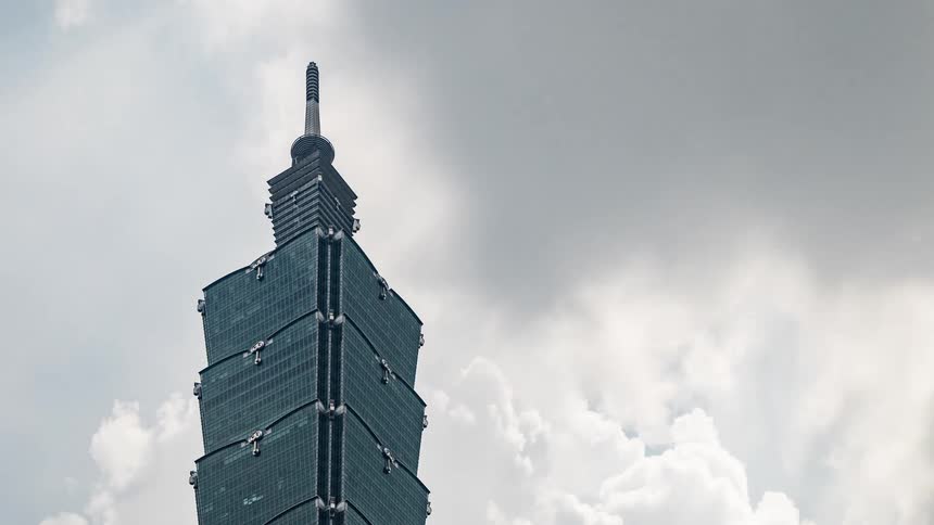 Time lapse of clouds moving over an high rise office building