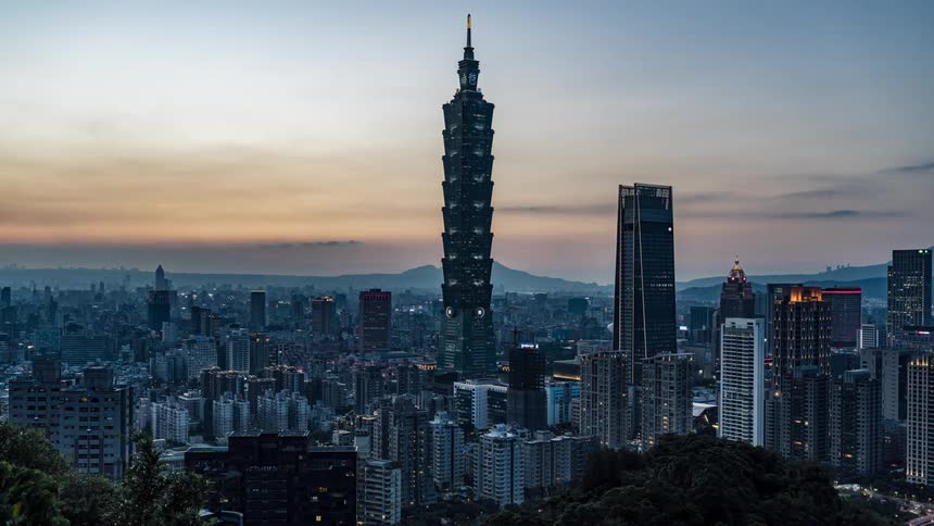 Tall skyscrapers in a large city at sunset and night