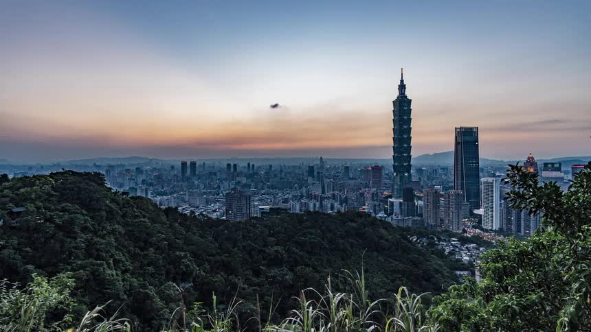 The sun setting behind skyscrapers and buildings in a large city