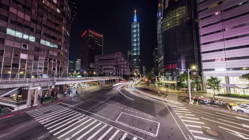 Pedestrians and vehicles at an intersection with crosswalks in a large city