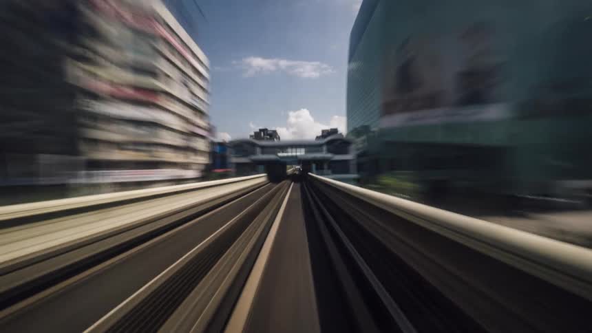 Time lapse of a train driving through stations in the city