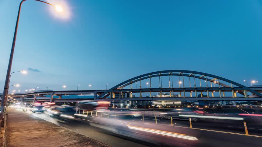 Timelapse view of cars and pedestrians is displayed