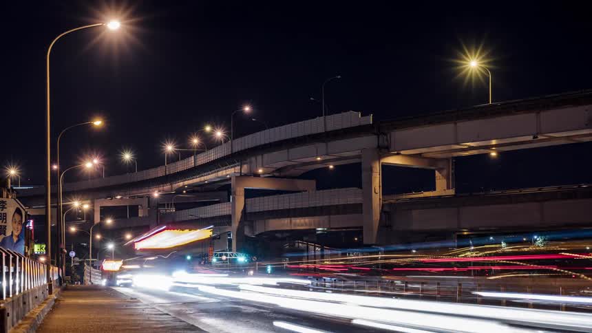 Time lapse view of cars driving in a city at night