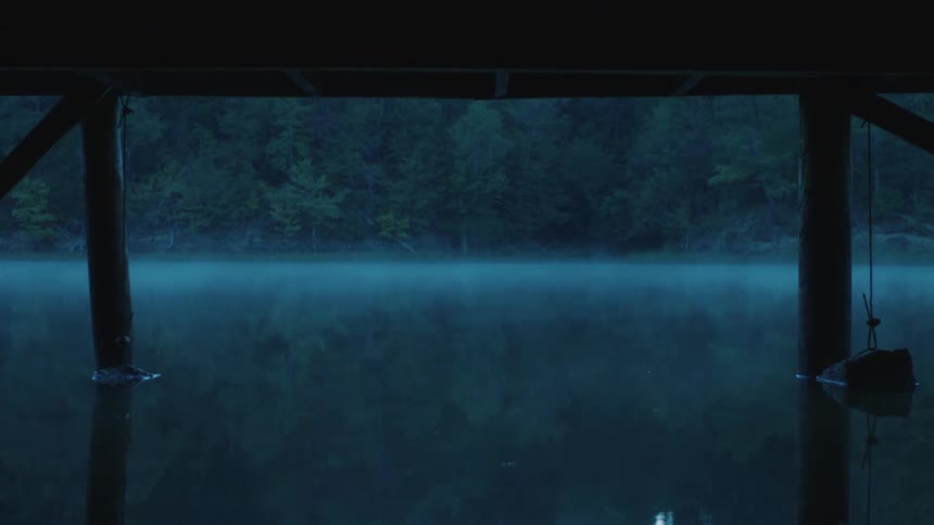Fog is forming on the lake at dusk