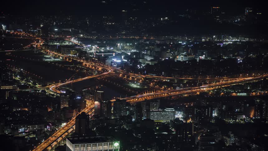 Timelapse aerial view of vehicles driving on the city highways at night
