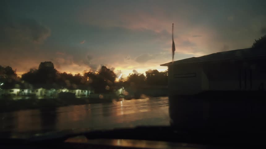 The sun is shining in the horizon of a rural community