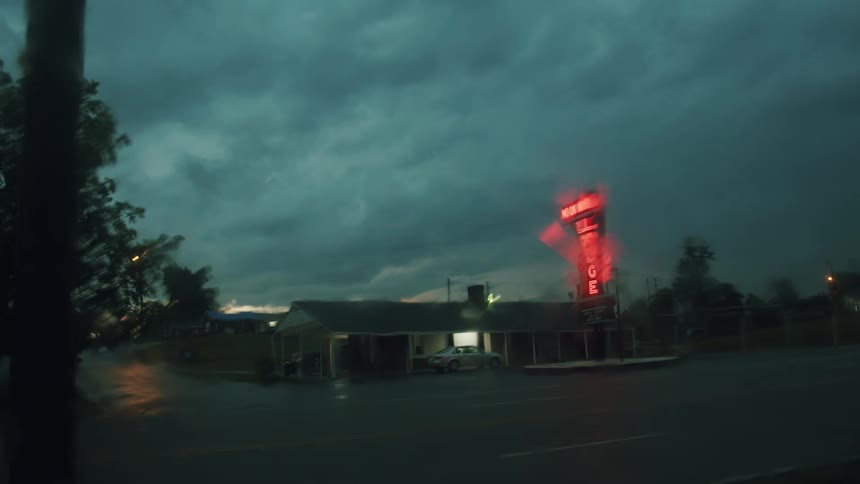 A view of a building with cars driving by