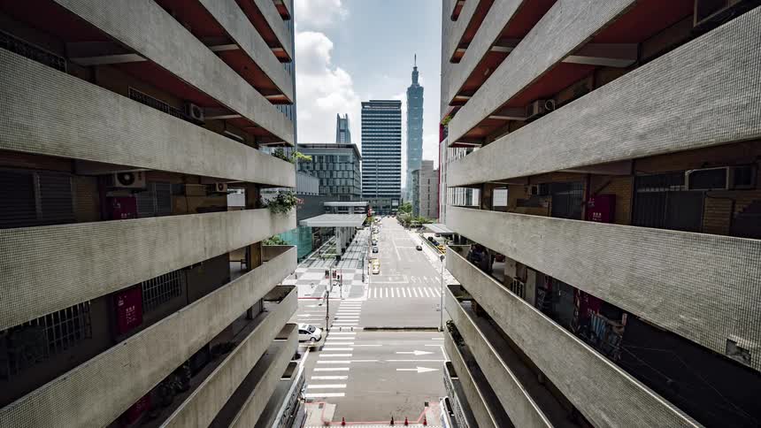Time lapse of cars and people on a city street filled with office buildings
