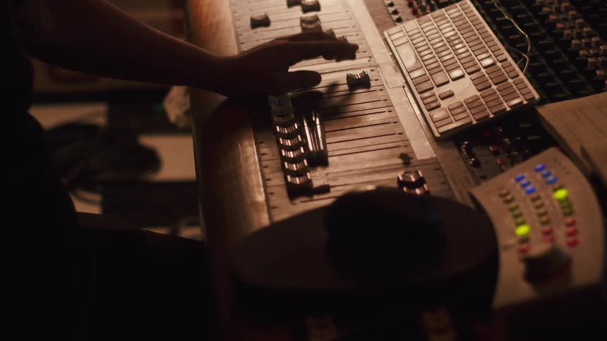 A person is using a sound mixer