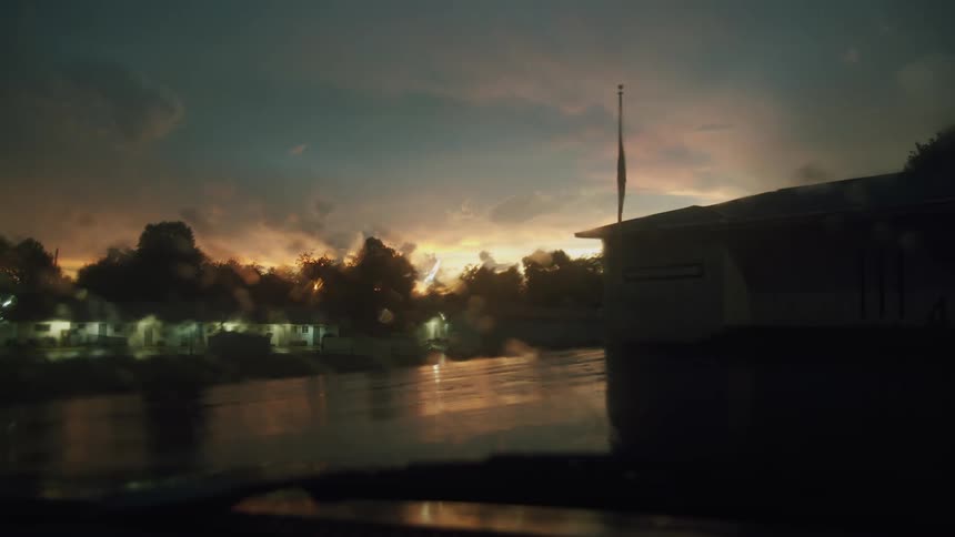 The sun is setting in the horizon of the suburbs