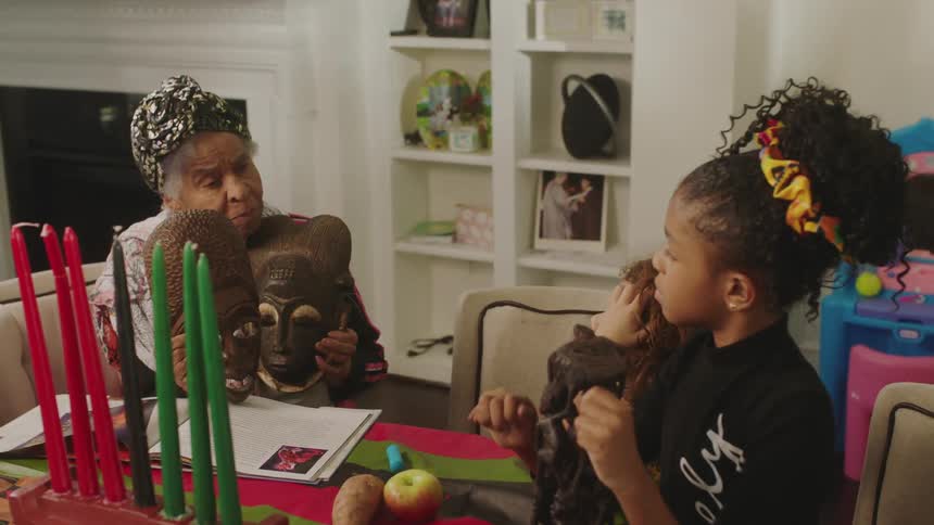A grandmother is showing her grandkids two masks