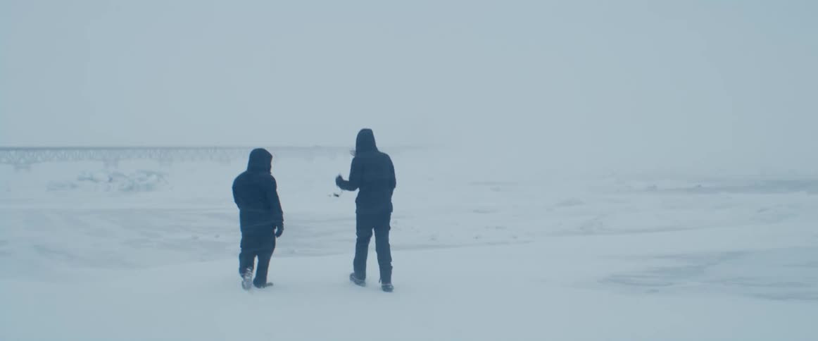 Two people are walking in the arctic together