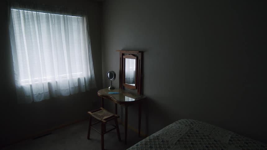 A mirror is on a table in the bedroom