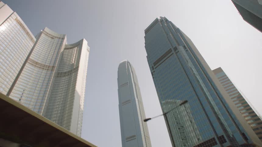 A view through town looking up at tall skyscrapers high in the sky