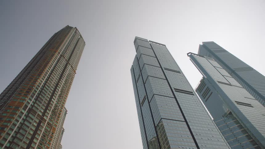 A view looking up at tall skyscrapers high in the sky