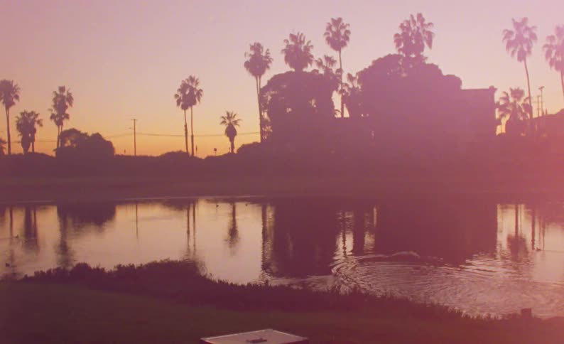 The sun flares on the stream by the house
