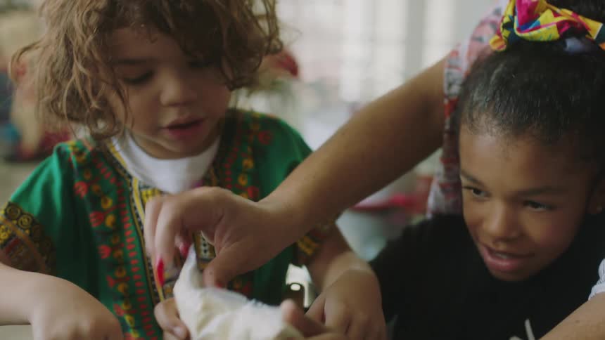 Children cook with a woman at home