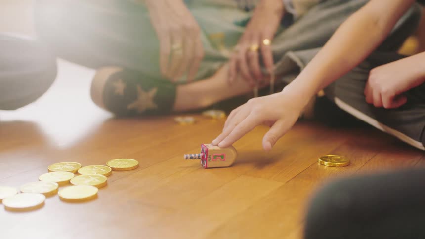 Mother plays game with children that uses chocolate coins as tokens
