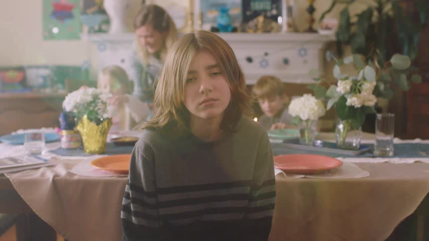 A family is sitting together in the dining room