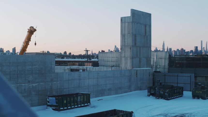 A layer of snow covers the surface of a building under construction near downtown