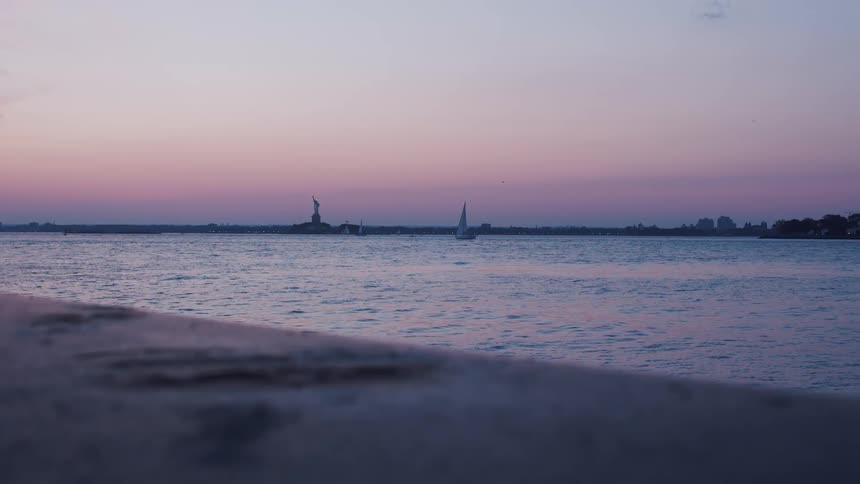 A view across the river and the statue of liberty in the distance