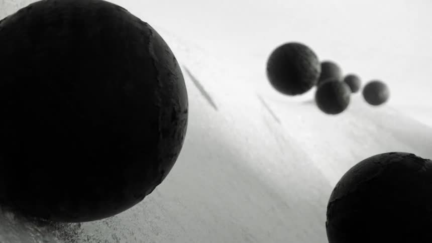 Computer generated graphics of black spheres floating over the surface of white slopes