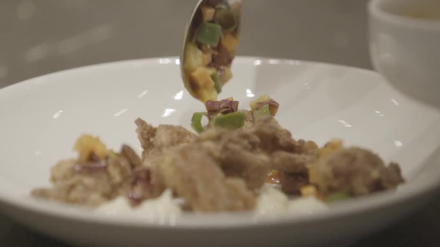 A dish of food is being prepared