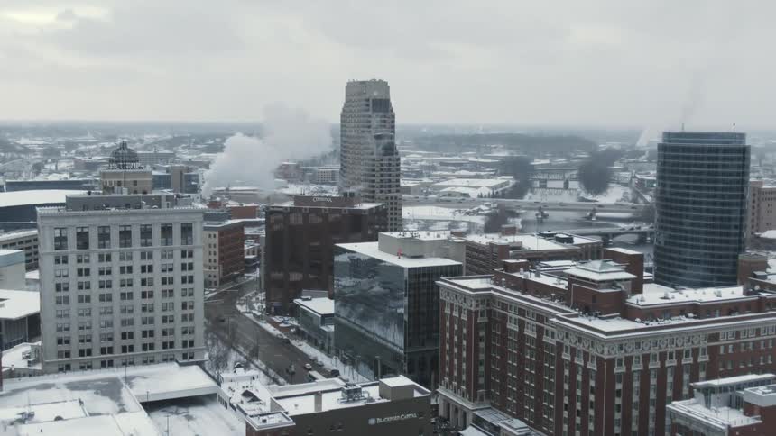 The buildings are covered with snow in the city