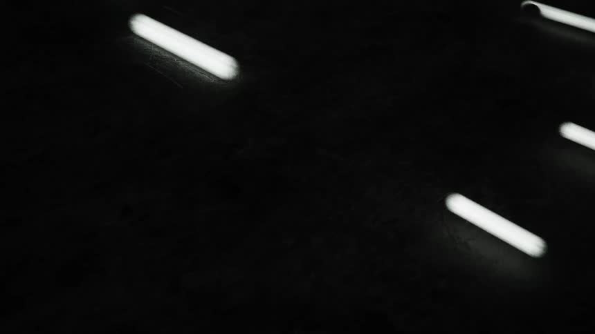 Animated computer graphics of bright tubes of light moving over a dark surface