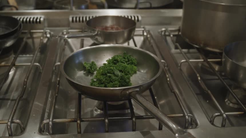 Vegetables are placed into a pan to cook