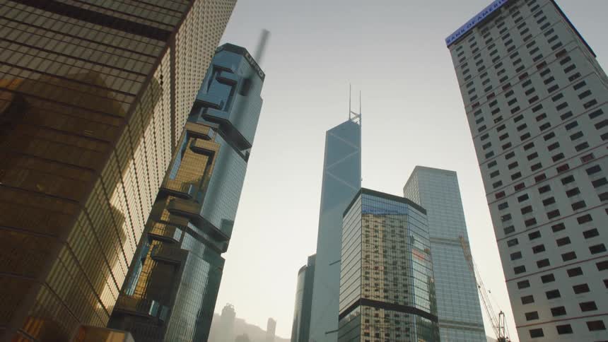 High rise city buildings seen from moving car on highway