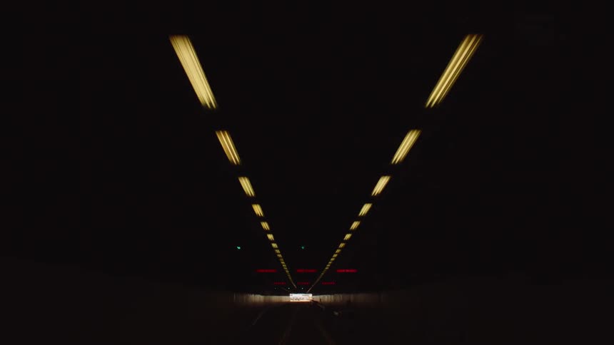 Vehicles travel in the dark tunnel