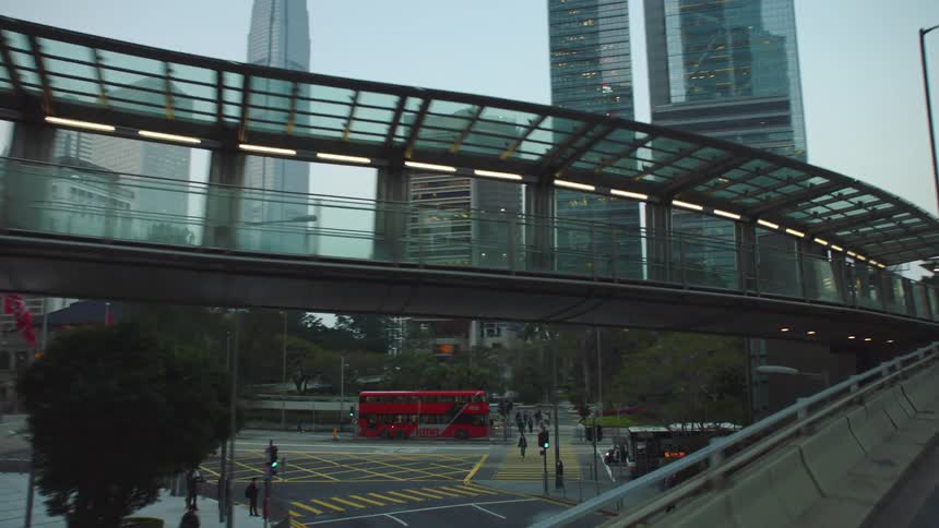 Footage of the city downtown and skyline filmed from a vehicle moving on a highway at morning