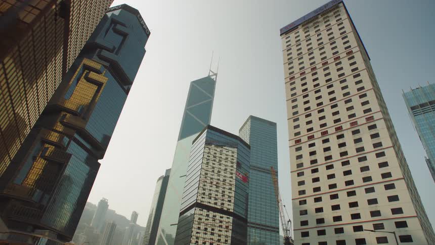 Sun shines down onto intricately designed skyscrapers in downtown tower block
