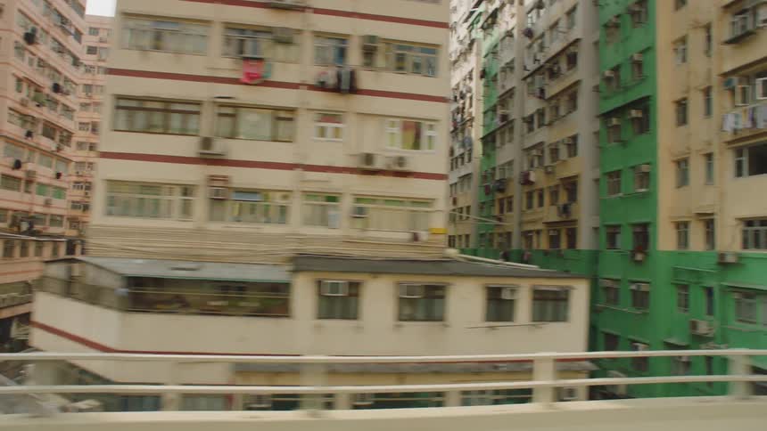 Rows of apartment buildings in china filmed from a highway at morning