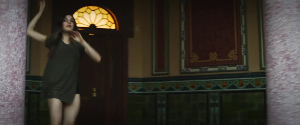 A contemporary dancer twirls and lifts in a hall with columns art and stained glass