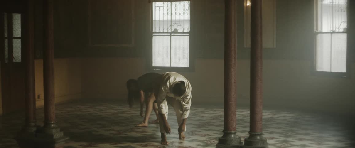 Man and woman are dancing on the floor in a room