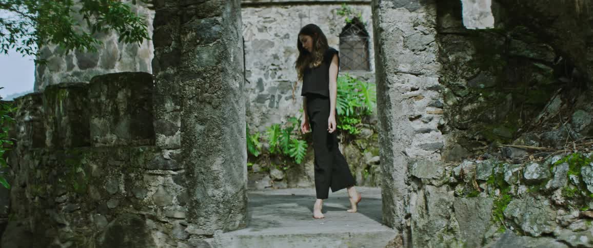 A woman is walking outdoors in spring