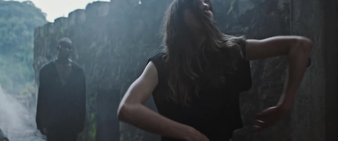 Man and woman are dancing outdoors together