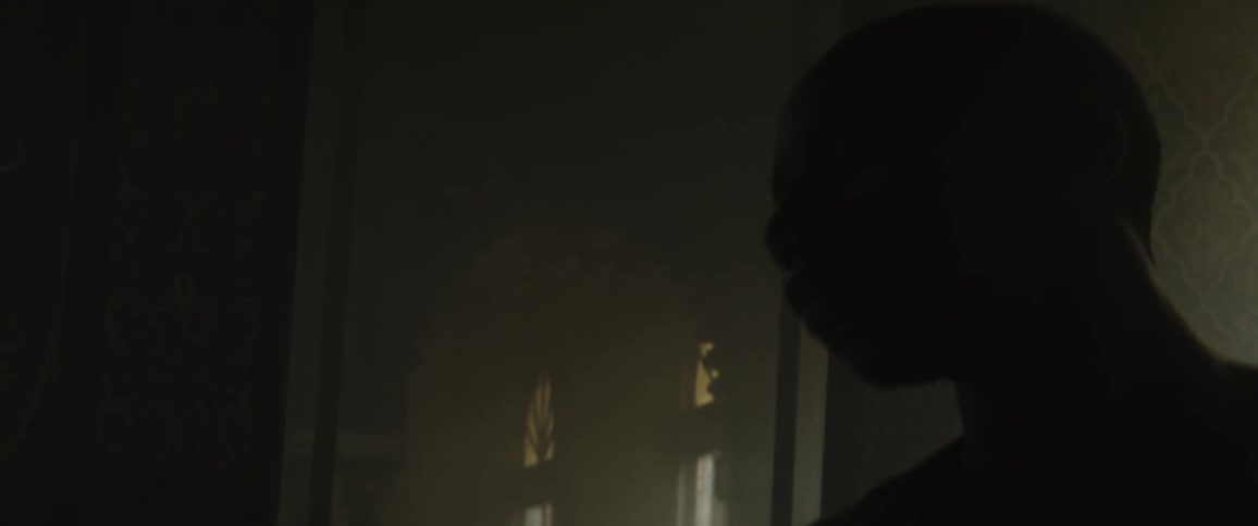 Man dances in shadowy room with ornate tiles as light flows in through windows