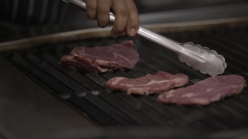 Steaks are places on a grill